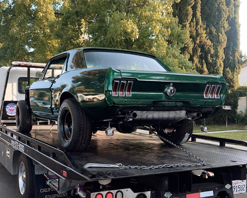 moss green ford mustang on trailer