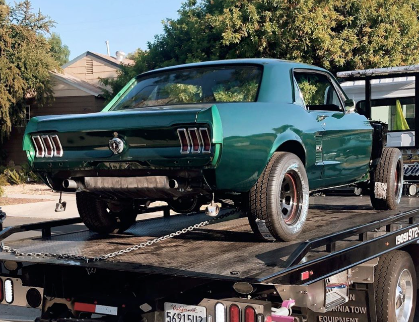 moss green ford mustang on trailer