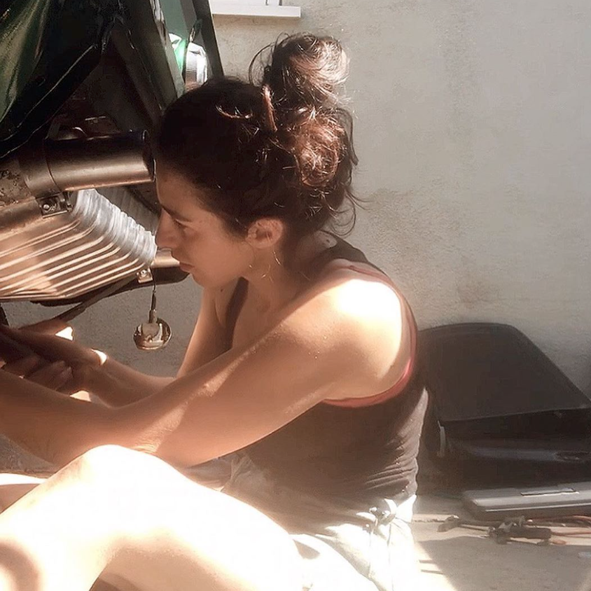 woman installing exhaust on 1967 Ford Mustang