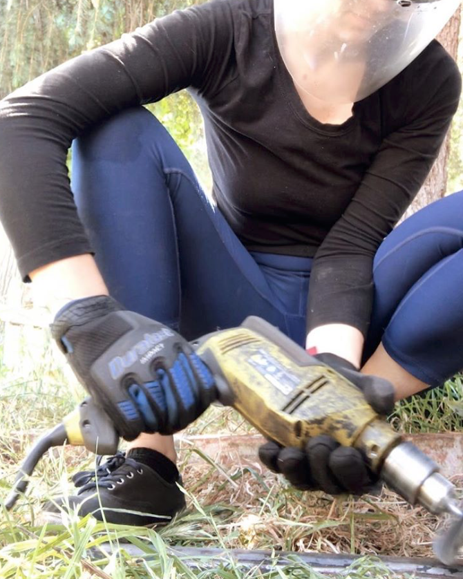 woman cleaning off car parts